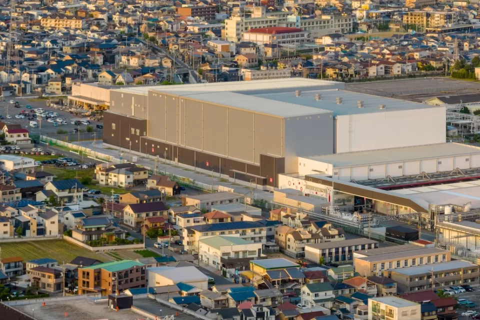 Aerial view of large warehouse in neighborhood.